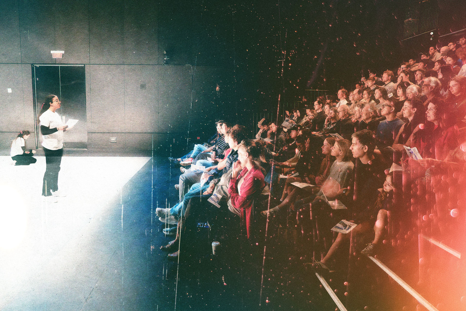 Student performer addressing a sold out audience.