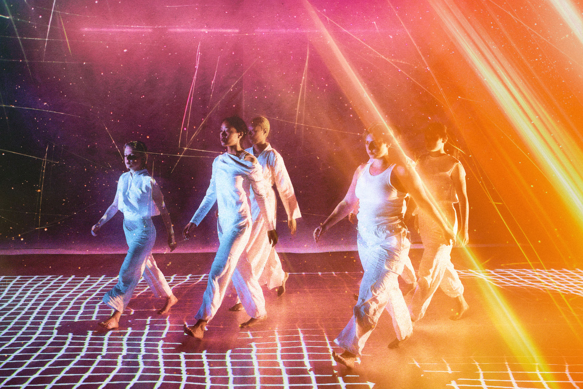 Student performers walking across a high-tech stage set.